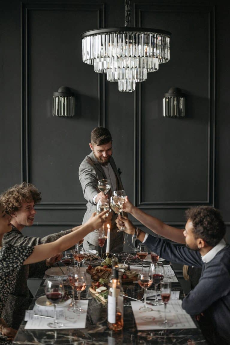 Elegant dining celebration with friends, featuring a luxurious table, vibrant dishes, and joyful toasts.