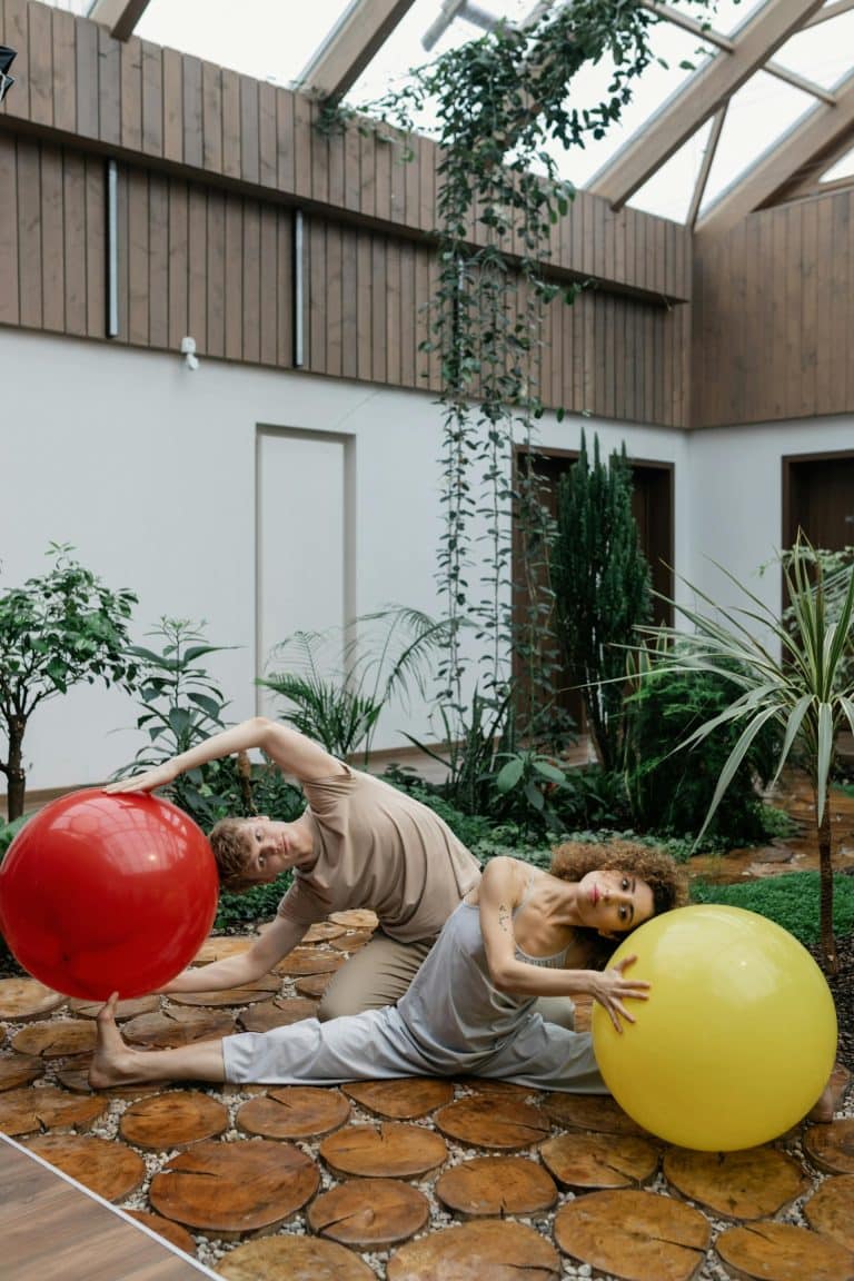 Energetic workout with colorful exercise balls in a serene, nature-inspired indoor setting.
