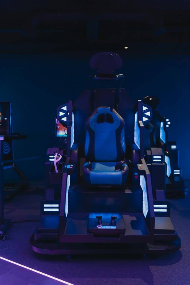 Futuristic blue gaming chair with neon lights for immersive virtual reality experiences.