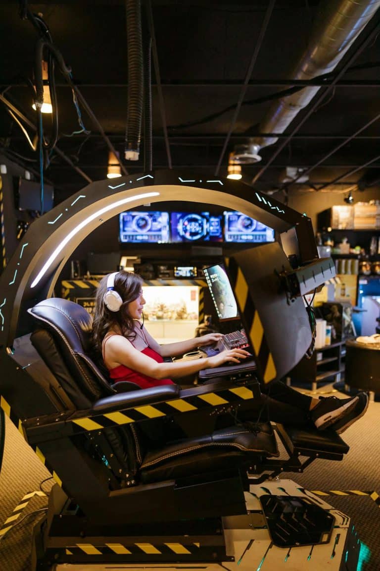 Futuristic gaming pod with immersive screens and ergonomic chair for an advanced virtual experience.