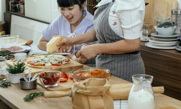 Cooking together in a bright kitchen, enjoying fresh ingredients and joyful moments.