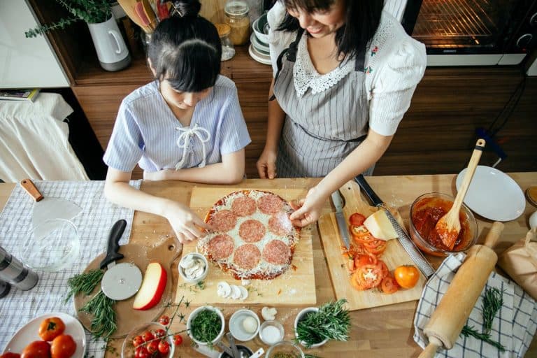 Enjoying a joyful pizza-making experience together in a cozy, inviting kitchen.
