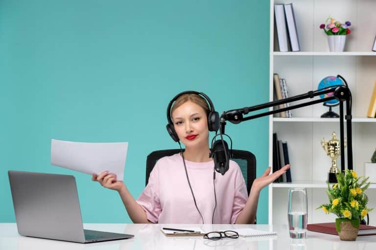 Confident woman recording a podcast in a modern, vibrant workspace with stylish decor.