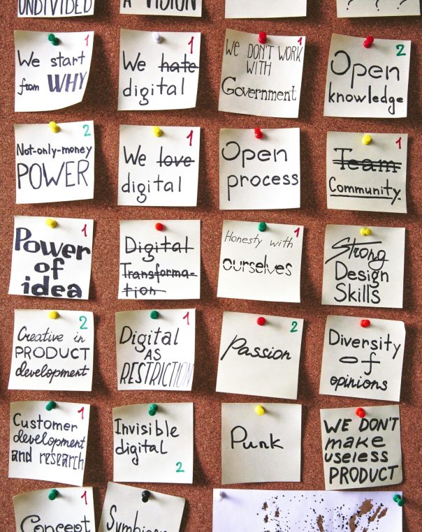Colorful sticky notes on a corkboard capture dynamic digital innovation and collaborative ideas.