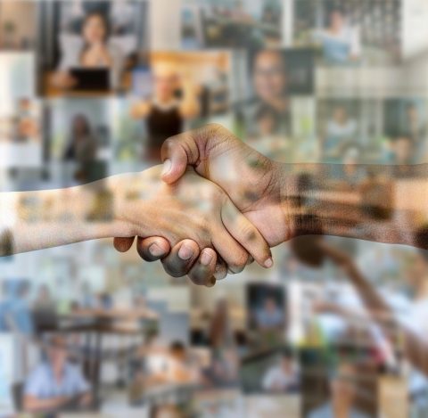 Dynamic handshake symbolizing trust and collaboration in a professional environment.