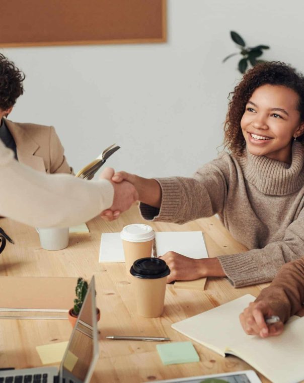 Warm handshake in a modern office exemplifying successful business collaboration and teamwork.