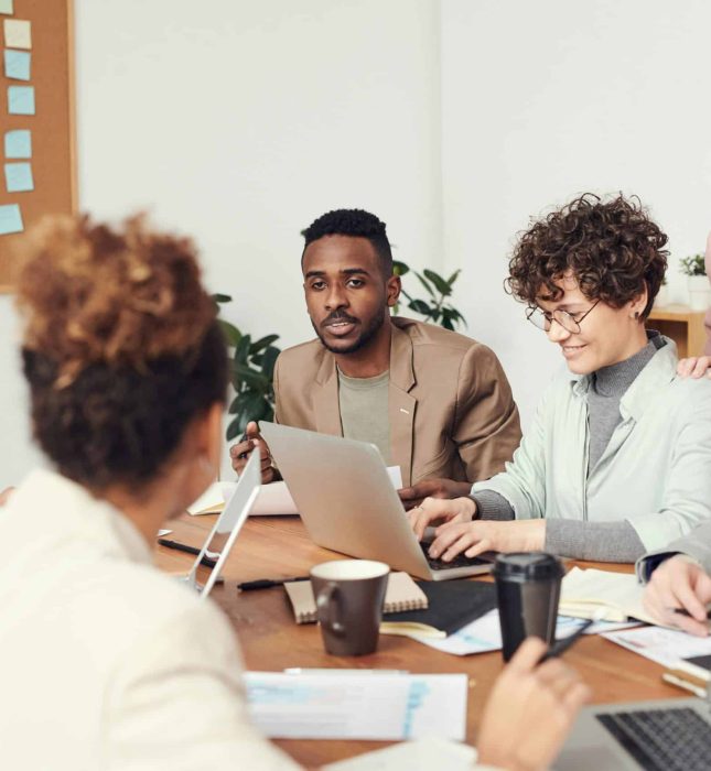 Engaged team brainstorming session highlighting collaboration, creativity, and diverse perspectives in a warm setting.