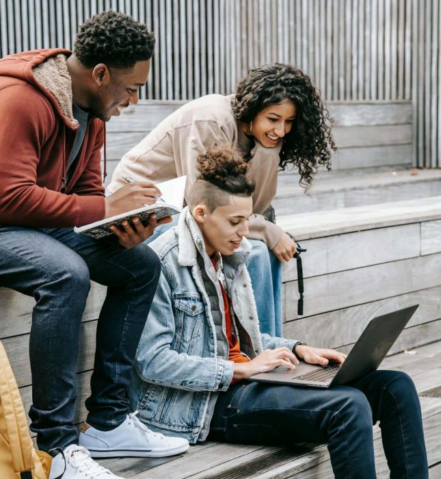 Young friends collaborating on a study project in a stylish, modern environment.