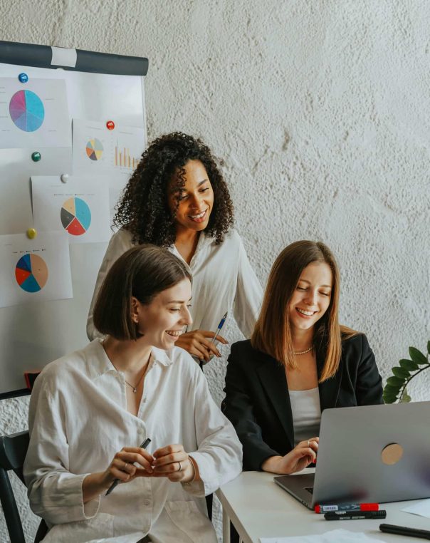 Empowered women collaborate creatively in a bright, modern workspace, showcasing teamwork and engagement.