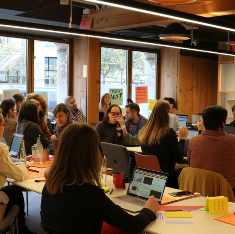 Diverse team collaborates in a bright, modern workspace filled with creativity and active discussions.