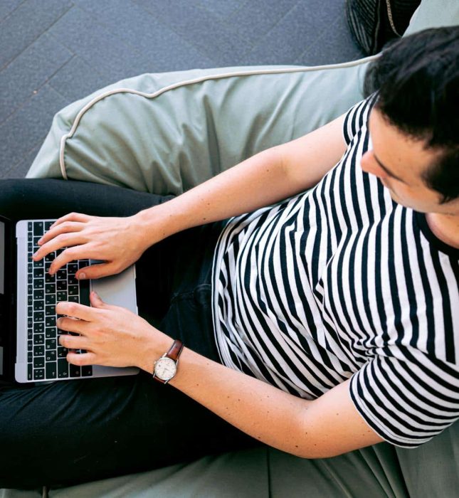 Cozy beanbag setup for productive work, featuring a laptop and warm natural light.