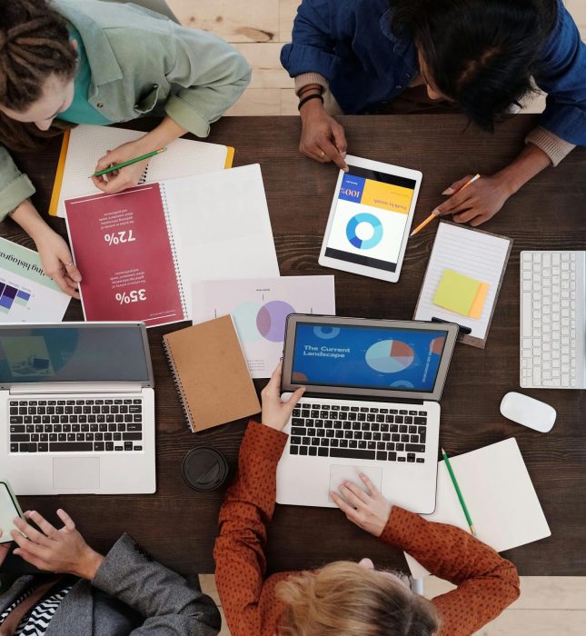 Team collaboration in a vibrant workspace focused on creativity, technology, and data analysis.