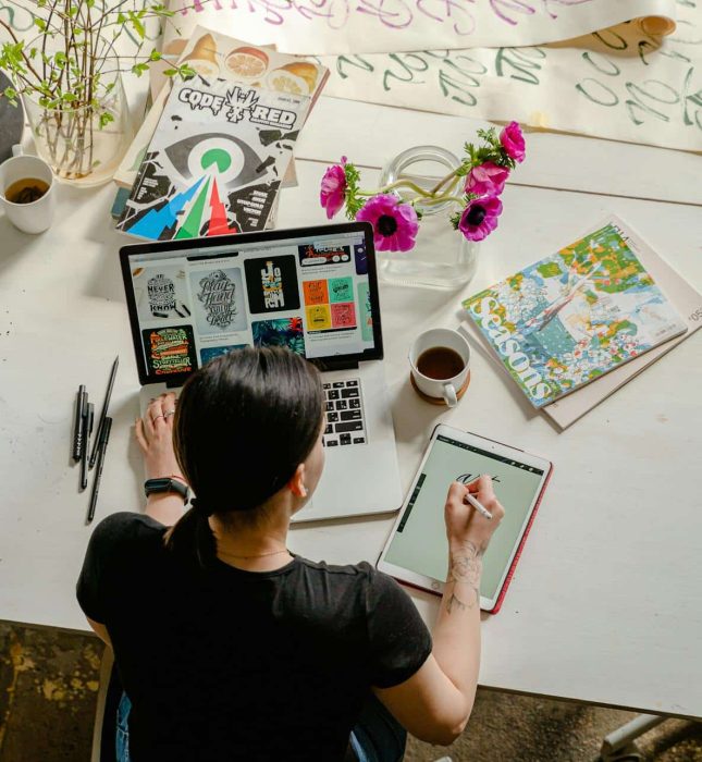 Artist at work in a vibrant, inspiring creative workspace filled with art supplies and ideas.
