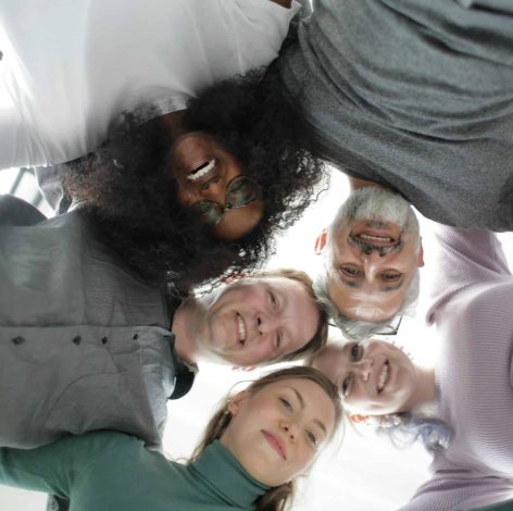 Five friends joyfully connect in a bright, modern space, showcasing unity and individuality.