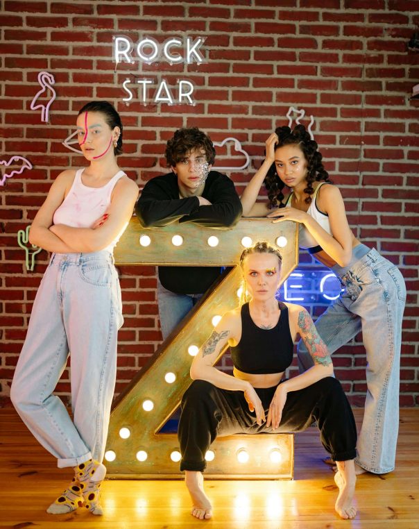 Vibrant group photo with illuminated Z, showcasing diverse styles and youthful creativity.