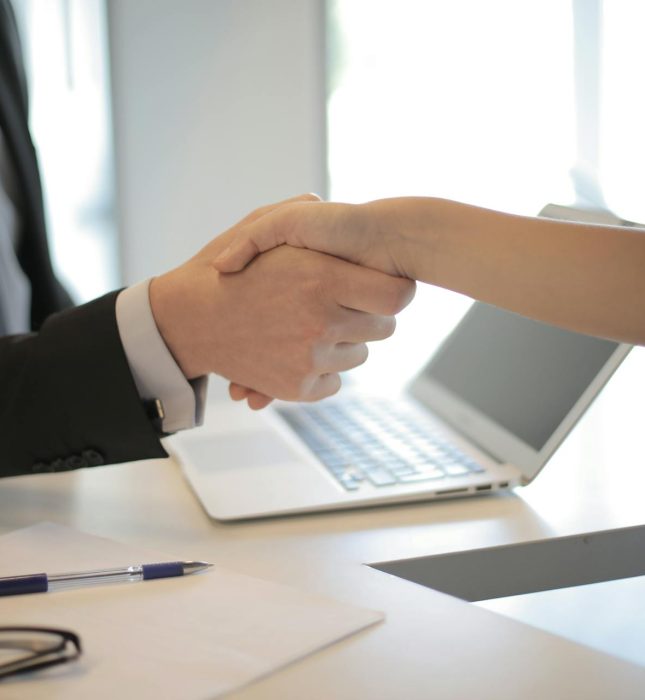 Handshake in a modern office: blending professionalism with casual approachability.