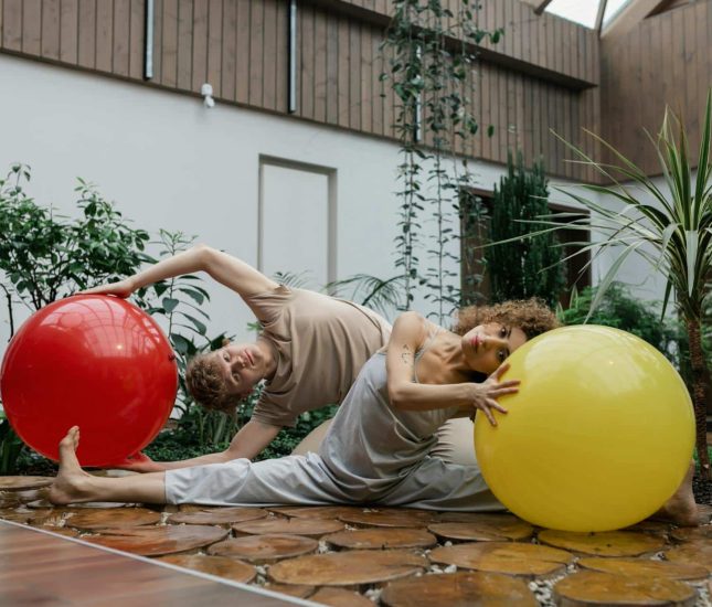 Dynamic indoor exercise with vibrant colors and lush greenery promoting balance and creativity.