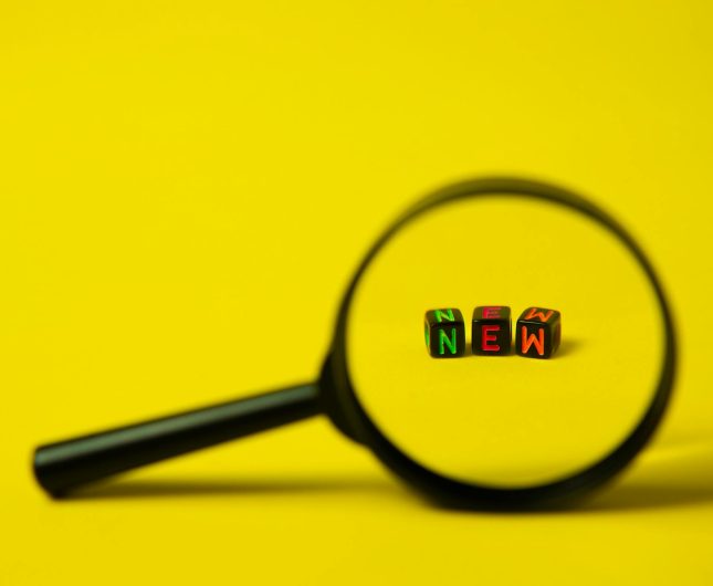 Explore new possibilities with curiosity through colorful blocks on a vibrant yellow background.