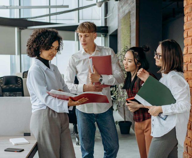 Young professionals collaborate in a bright, modern office, sharing ideas and insights.