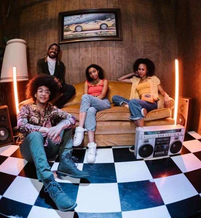 Friends relax in a cozy retro room, enjoying music and each others company.