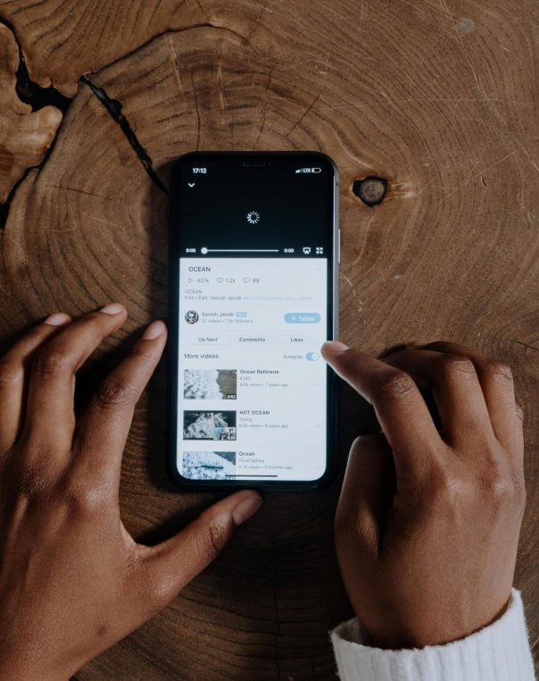 Smartphone interaction on rustic wood, showcasing technology intertwined with natural beauty.