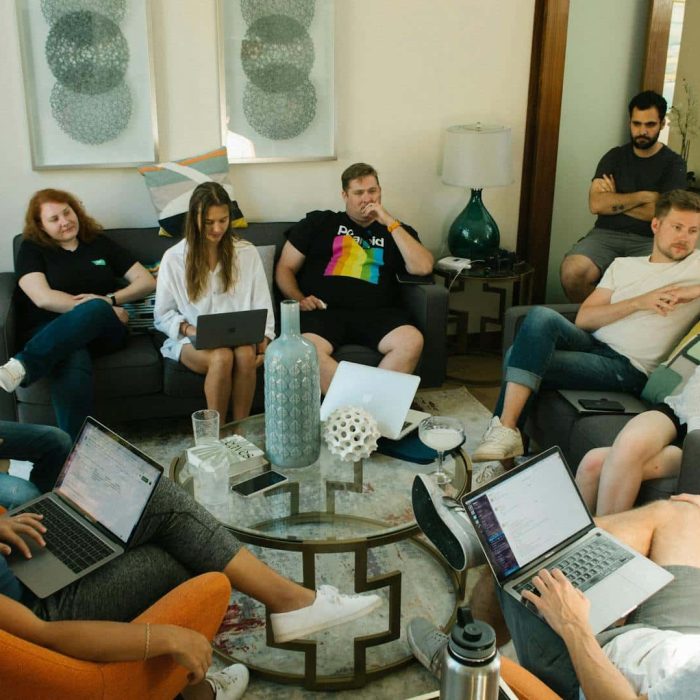 Diverse team collaborating in a bright, modern workspace during a lively brainstorming session.