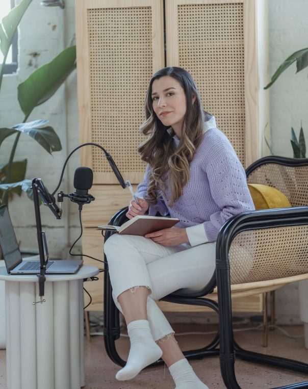 Woman working on a laptop in a bright, modern space with stylish decor.