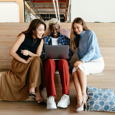 Women collaborating in a modern workspace, showcasing teamwork and a vibrant, inspiring atmosphere.