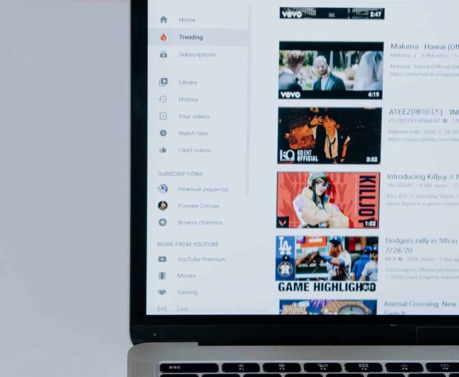 Close-up of a laptop displaying an engaging YouTube interface with vibrant video thumbnails.