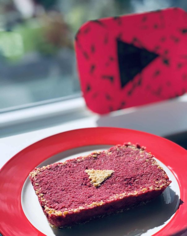 YouTube play button dessert: vibrant red treat with yellow triangle, perfect for digital media fans.